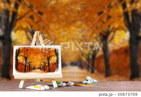 Easel with a watercolor painting of the autumn alley.  30673709