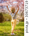 Beautiful happy young woman in a flowering spring garden 30673719