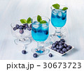 Alcoholic cocktail with blueberries and mint.  30673723