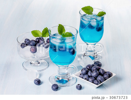 Alcoholic cocktail with blueberries and mint.  30673723