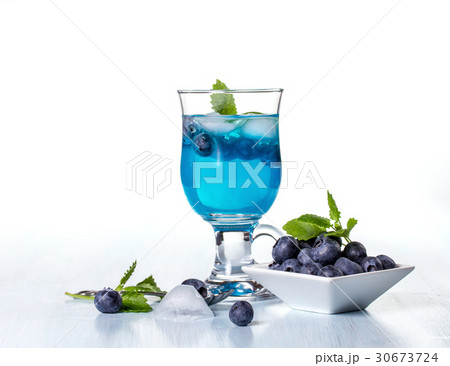 Alcoholic cocktail with blueberries and mint.  30673724