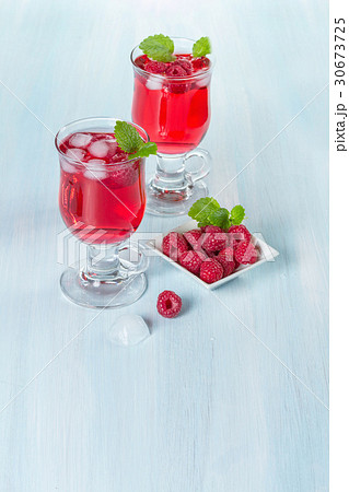 Alcohol cocktail with raspberries and mint 30673725