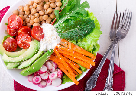 Vegan buddha bowl on white wooden background. Vegan buddha bowl on white wooden background. 30673846