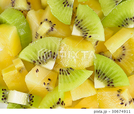 Many slices of kiwi fruit on background. 30674911