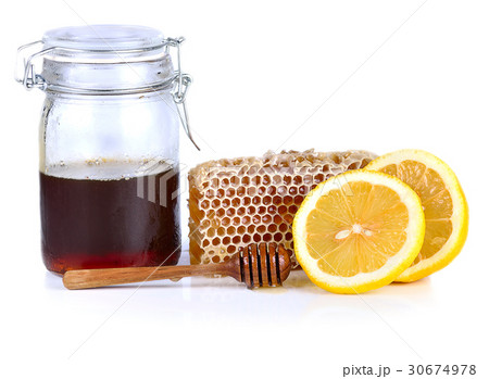 Honey and lemon isolated on white background. Honey and lemon isolated on white background. 30674978