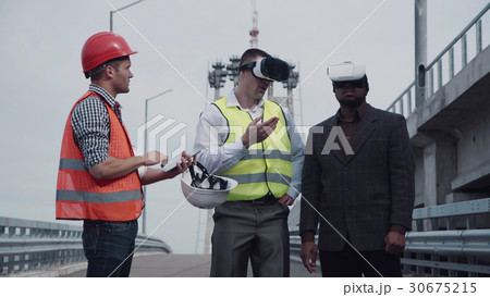Architects discussing project in virtual reality Architects discussing project in virtual reality 30675215