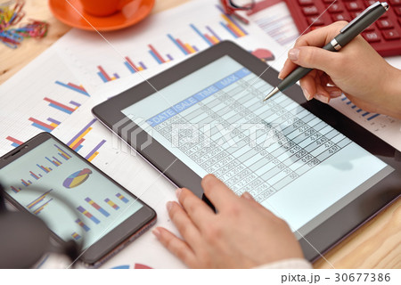 businesswoman hand analyzing income data 30677386