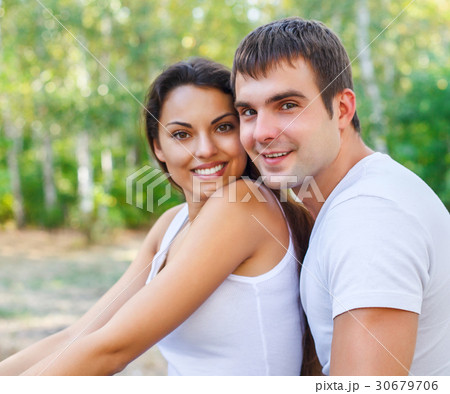 Portrait of a happy couple laughing at camera Portrait of a happy couple laughing at camera 30679706