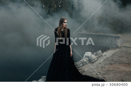 Young attractive Witch walking on the bridge Young attractive Witch walking on the bridge 30680400