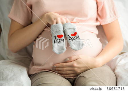 Young preganant woman expecting a baby relaxing on Young preganant woman expecting a baby relaxing on 30681713