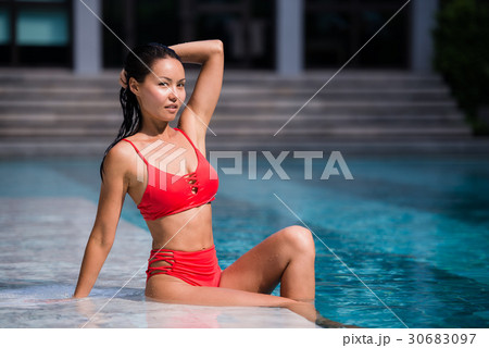 Portrait of beautiful, young lady in red bikini Portrait of beautiful, young lady in red bikini 30683097