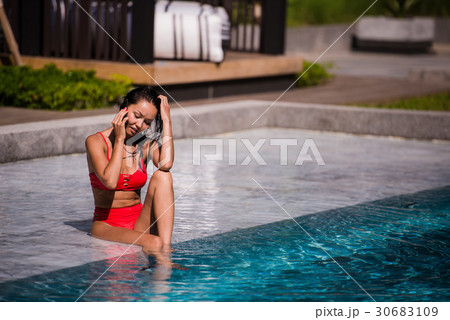Attractive woman talking on her mobile phone by 30683109