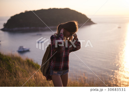 Hipster stylish woman traveler looking on a sea or 30683531