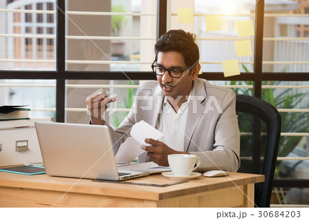 indian male typing resignation letter 30684203