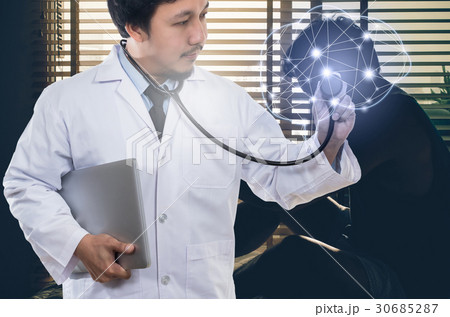 Asian Doctor hand holding the laptop and stethoscope equipment on brain over depressed man sitting head in hands on the bed in the dark bedroom, physician of darmatic concept Asian Doctor hand holding the laptop and stethoscope equipment on brain over depressed man sitting head in hands on the bed in the dark bedroom, physician of darmatic concept 30685287