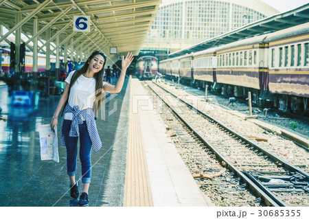 Asia woman Traveller feeling happiness and greeting her friend before go to travel at the train station, Travel and lifestyle concept 30685355