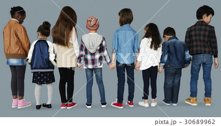 Group of diverse kids students standing in a row holdings hands Group of diverse kids students standing in a row holdings hands 30689962