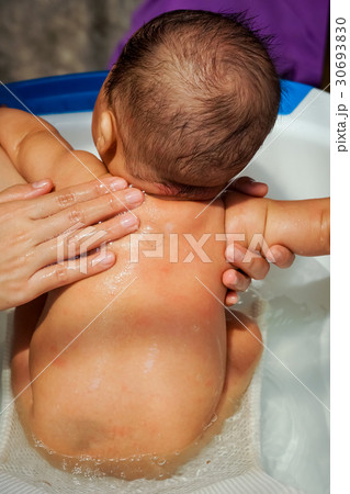 Asian newborn baby having a bath Asian newborn baby having a bath 30693830