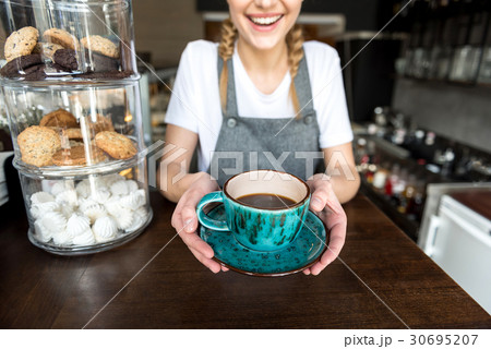 Arms of woman serving beverage 30695207