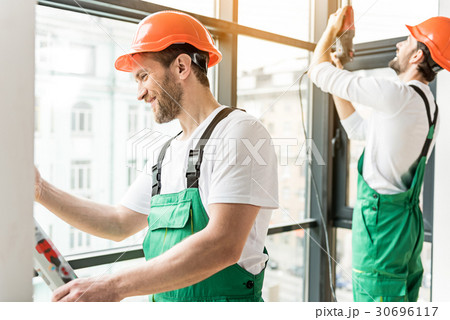 Happy smiling constructors working together Happy smiling constructors working together 30696117