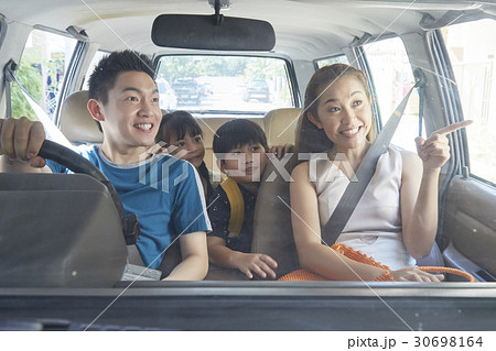 A happy family is travelling together by car. 30698164