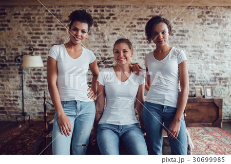 Three attractive girls in white T-shirts are Three attractive girls in white T-shirts are 30699985