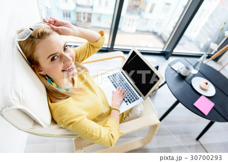 Joyful girl laboring in white chair Joyful girl laboring in white chair 30700293