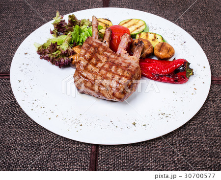 Delicious lamb racks with griled vegetables. 30700577