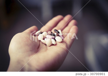 pills in woman hand, drug addiction 30700901
