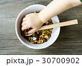 bowl with muesli and spoon on the wooden table  30700902