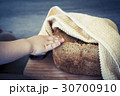 home made cereal bread in yellow cloth on wooden  30700910