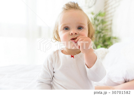 Pretty little child biting sweet pastry 30701582
