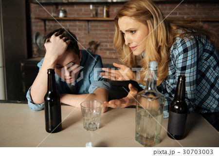 Worried woman looking at her son 30703003