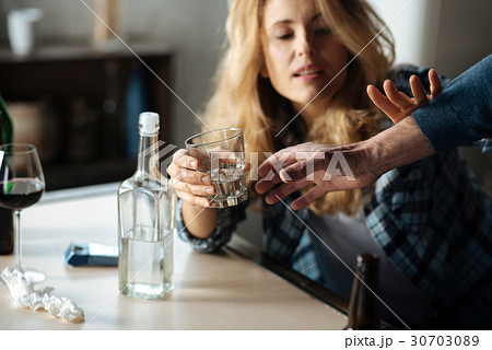 Close up of male hand while taking away glass with 30703089