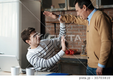Angry strong teenager catching hand over his head 30703810