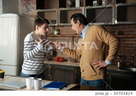 Shocked boy looking at his father 30703824