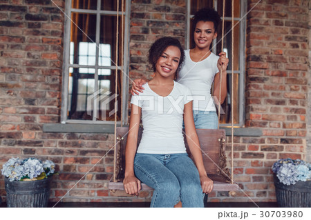 Attractive african american girl in white T-shirts Attractive african american girl in white T-shirts 30703980