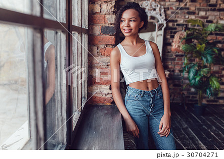 Beautiful african girl in white top standing near Beautiful african girl in white top standing near 30704271