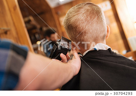 Experienced male hairdresser working with hair 30704293