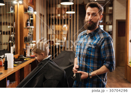 Nice good looking barber holding a comb 30704296