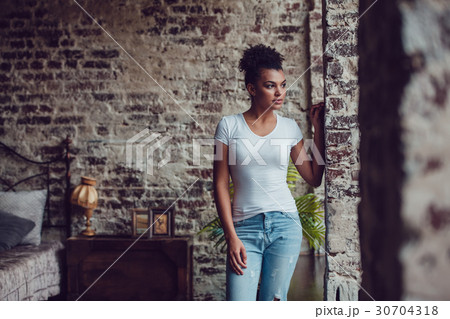 Beautiful african girl in white t-shirt standing 30704318