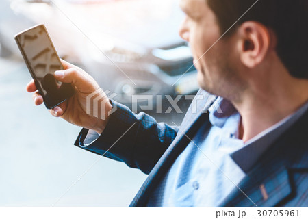 Happy businessman watching at mobile 30705961