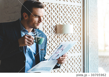 Calm man drinking mug of beverage 30705962