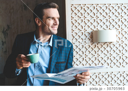 Smiling male tasting cup of coffee 30705963
