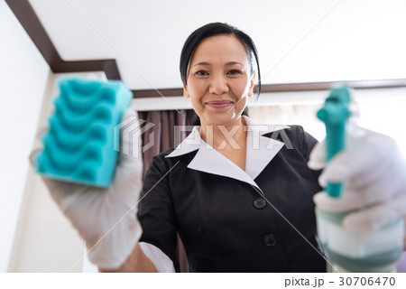 Positive joyful chambermaid being in a positive Positive joyful chambermaid being in a positive 30706470