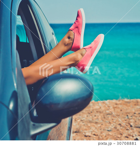 Female legs from the window of car 30708881