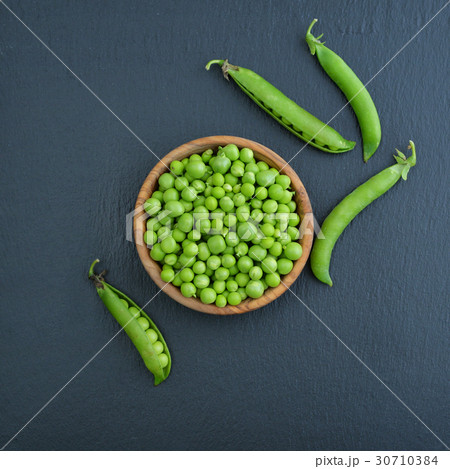 Green peas in wooden bowl Green peas in wooden bowl 30710384