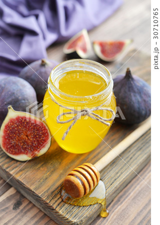 Honey in jar with honey dipper Honey in jar with honey dipper 30710765