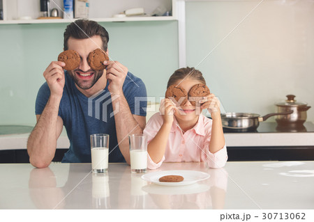 Young father and daughter having a snack meal Young father and daughter having a snack meal 30713062