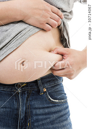 お腹の贅肉をつまむ太った男性の写真素材